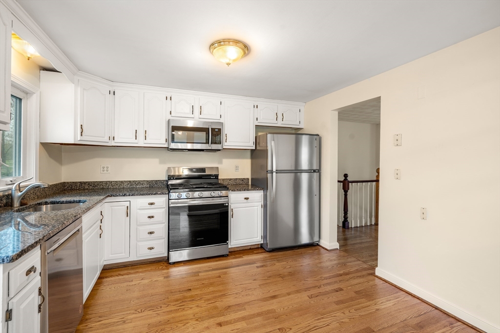 125 Lyman Road Milton, MA 02186 - Photo 14 of 25 a kitchen with granite countertop a refrigerator stove top oven and sink