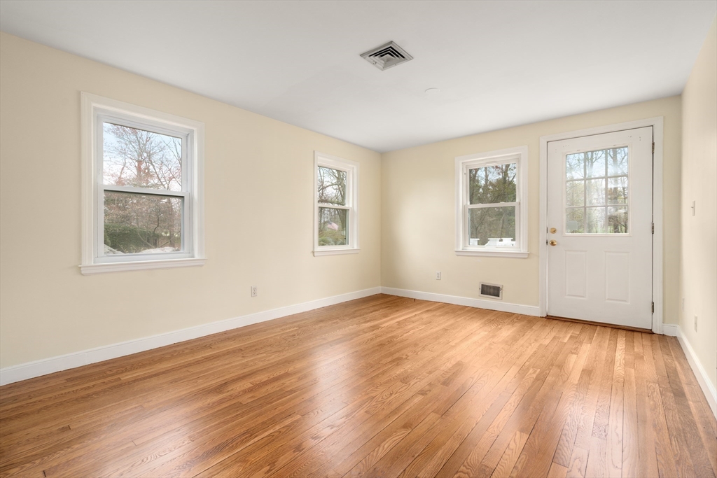 125 Lyman Road Milton, MA 02186 - Photo 15 of 25 a view of empty room with wooden floor and fan