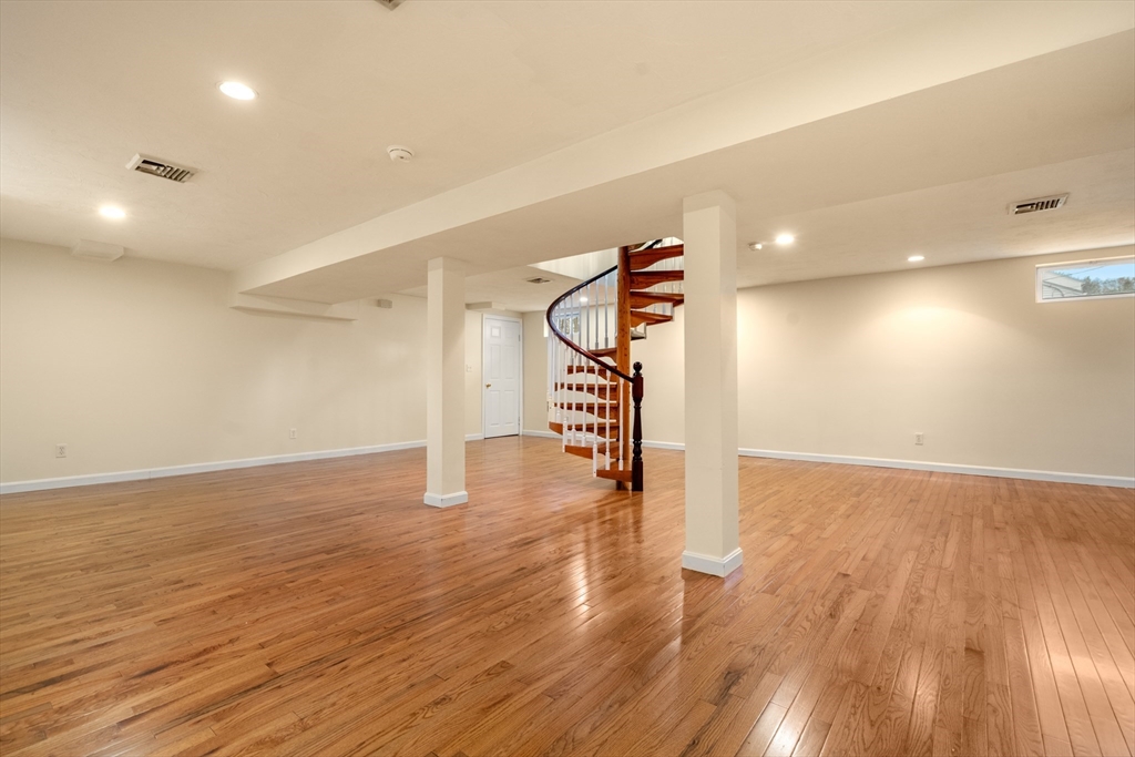 125 Lyman Road Milton, MA 02186 - Photo 18 of 25 a view of an empty room with wooden floor