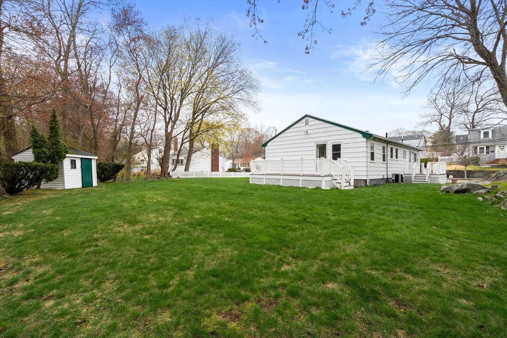 125 Lyman Road Milton, MA 02186 - Photo 23 of 25 a view of a white house in front of a big yard with large trees