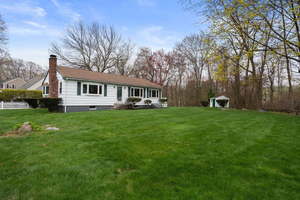 125 Lyman Road Milton, MA 02186 - Photo 24 of 25 a front view of a house with garden and trees