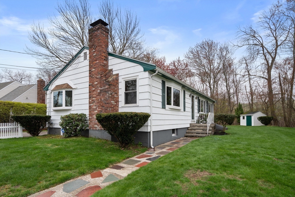 125 Lyman Road Milton, MA 02186 - Photo 25 of 25 a front view of a house with a garden and yard