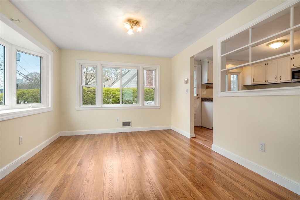 125 Lyman Road Milton, MA 02186 - Photo 8 of 25 an empty room with wooden floor and windows