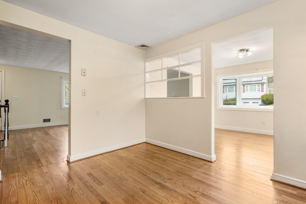 125 Lyman Road Milton, MA 02186 - Photo 9 of 25 an empty room with wooden floor and windows