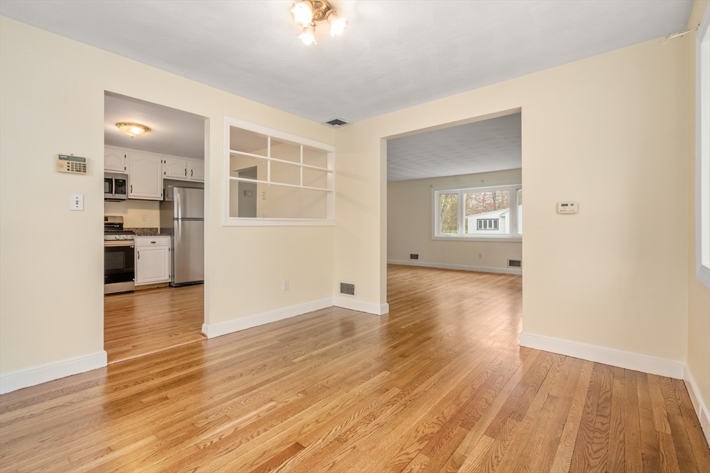 125 Lyman Road Milton, MA 02186 - Photo 10 of 25 wooden floor in an empty room with a workspace