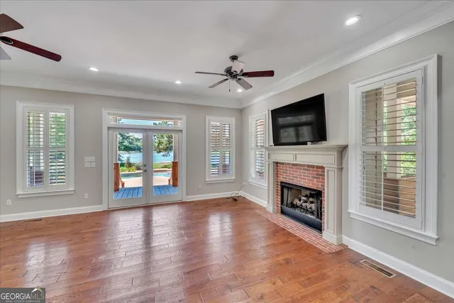 a bathroom with a granite countertop sink a toilet a mirror and shower curtain