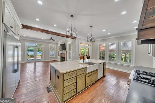 a open kitchen with white cabinets and stainless steel appliances