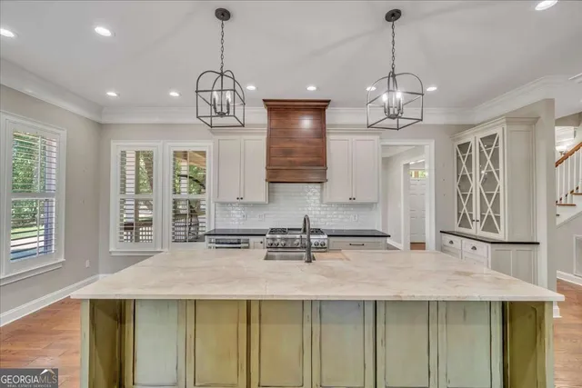 a kitchen with stainless steel appliances granite countertop a stove and a refrigerator