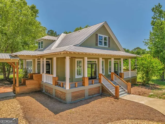 an aerial view of beach and residential houses with outdoor space
