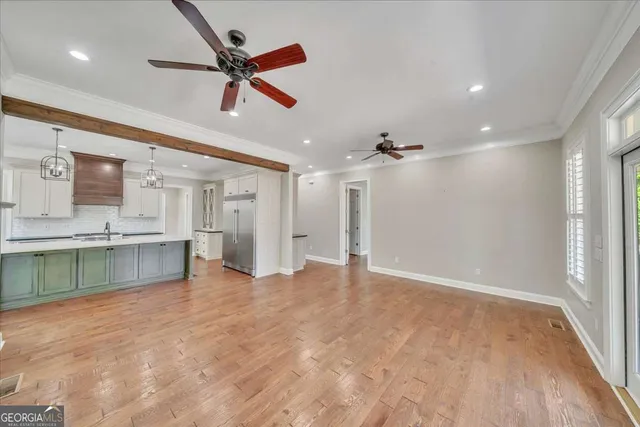a view of a livingroom with a fireplace window and wooden floor