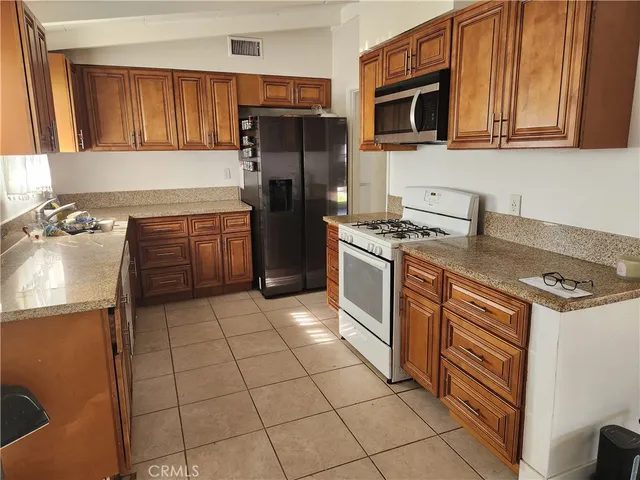 a kitchen with a stove a microwave and refrigerator