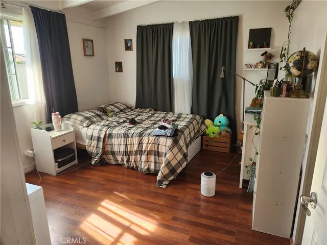 a bedroom with bed and a window