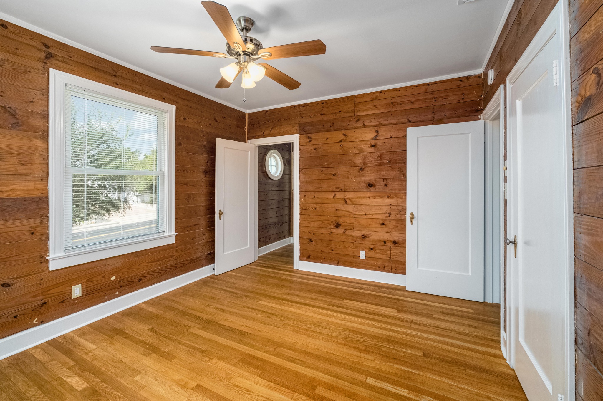 2012 Enfield Road, Unit B Austin, TX 78703 - Photo 12 of 20 Warm wood paneling and pristine hardwood floors define this welcoming bedroom space.