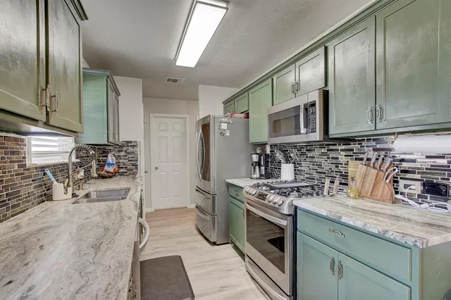 a bathroom with a sink mirror and toilet