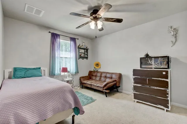 a living room with furniture gym equipment and a large window