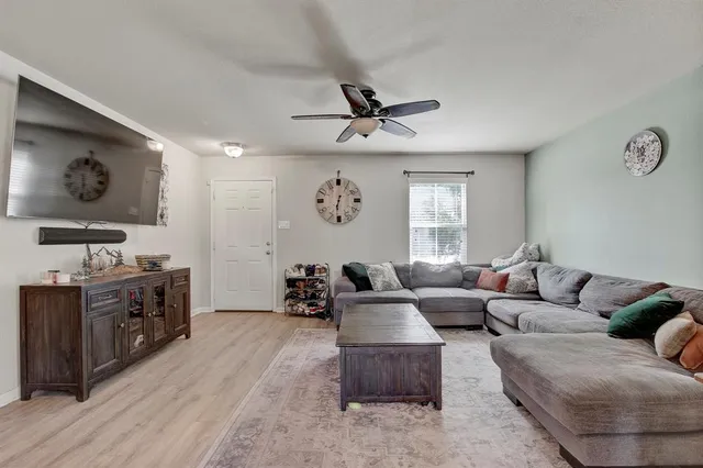 a view of a dining room with furniture a chandelier and wooden floor