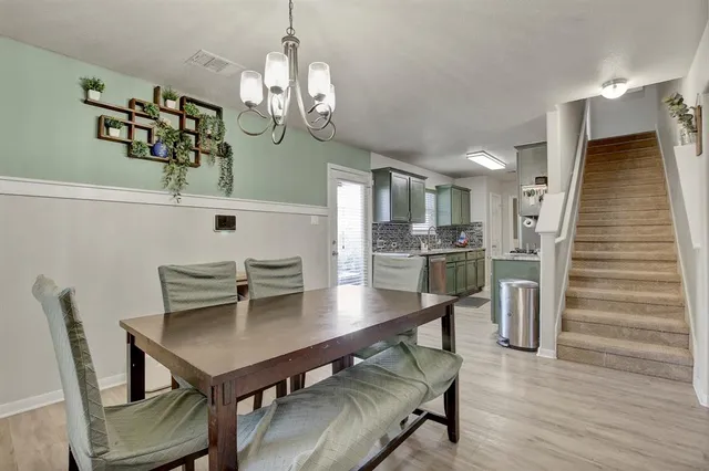 a kitchen with stainless steel appliances a sink stove and cabinets
