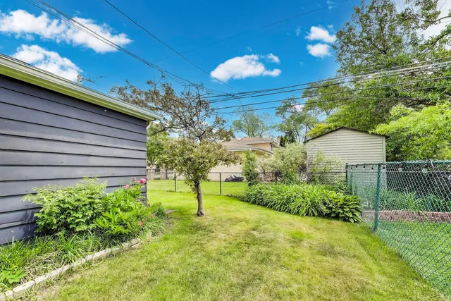a view of a backyard with plants and a lake view