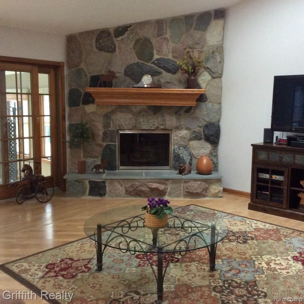2051 Hidden Valley Howell, MI 48843 - Photo 7 of 66 Custom cut fieldstone fireplace is perfect for this great room.