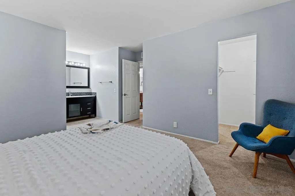 2157 Arnold Way, Unit 324 Alpine, CA 91901 - Photo 14 of 31 a bedroom with a bed a chair and a fireplace