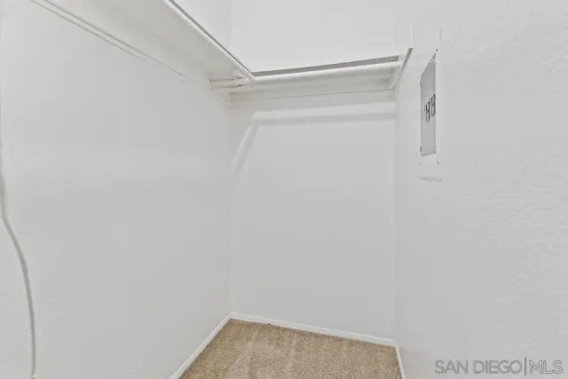 a view of walk in closet with clothes