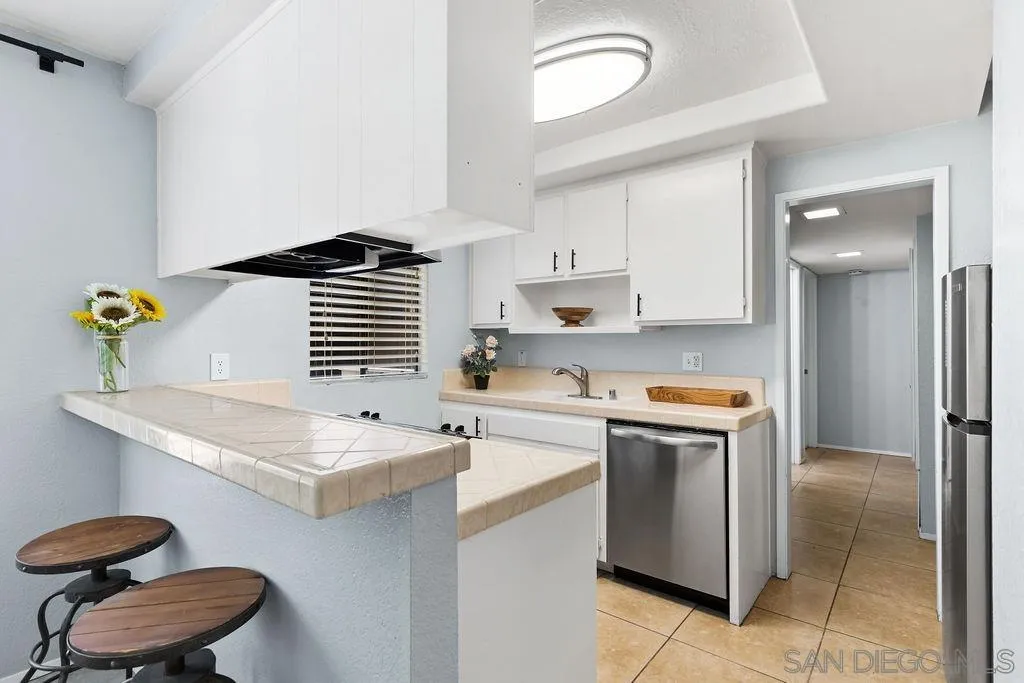 2157 Arnold Way, Unit 324 Alpine, CA 91901 - Photo 7 of 31 a kitchen with a sink a stove cabinets and a window