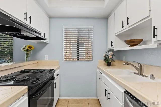 a kitchen with a sink stove and cabinets