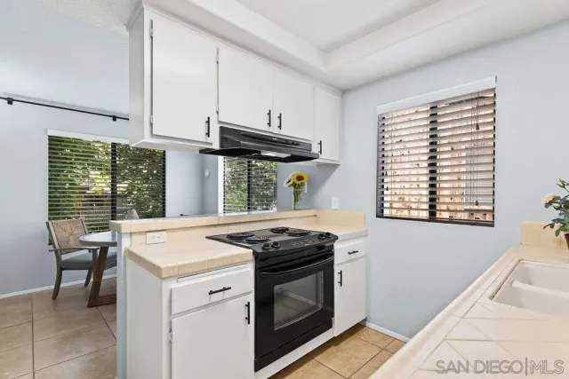 a kitchen that has a stove and a table in it