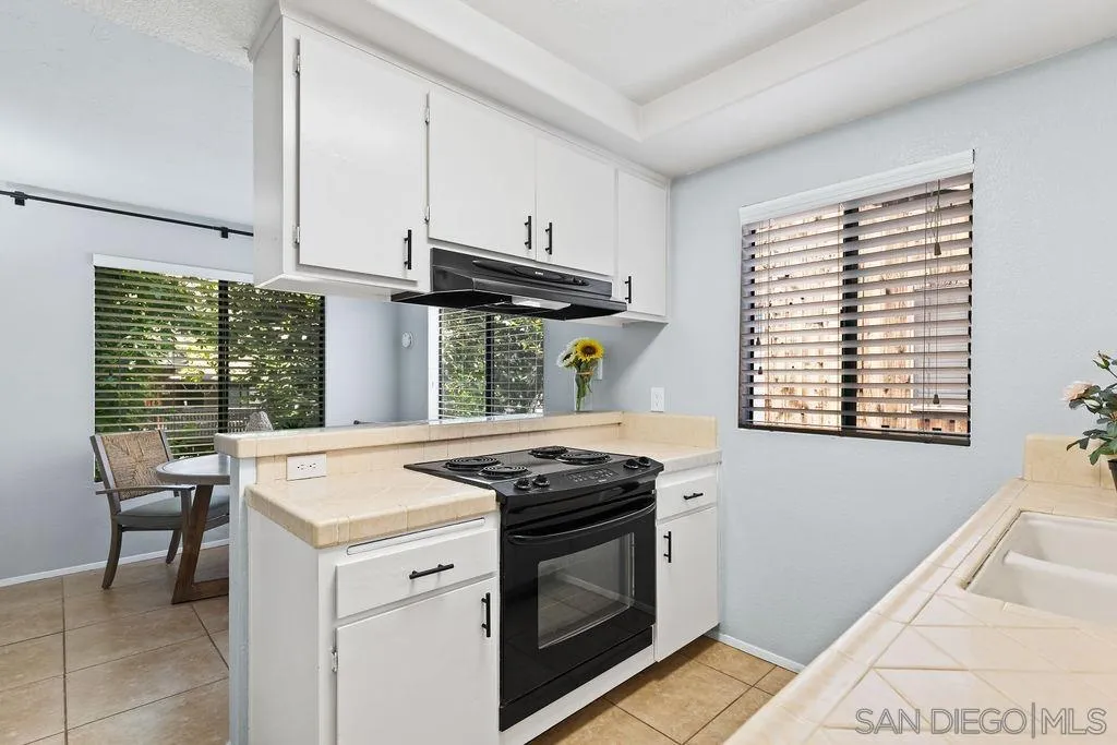 2157 Arnold Way, Unit 324 Alpine, CA 91901 - Photo 9 of 31 a kitchen that has a stove and a table in it