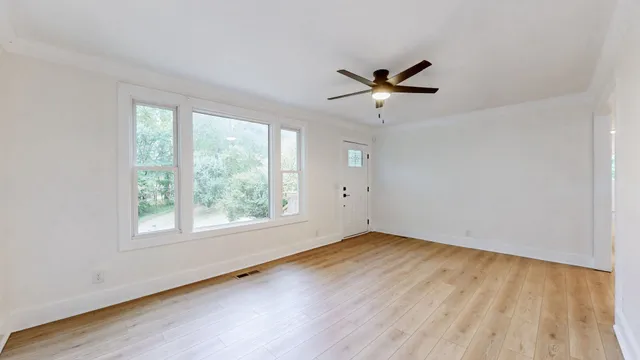 wooden floor in an empty room with a window