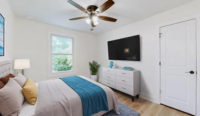 a bedroom with a bed and a flat screen tv