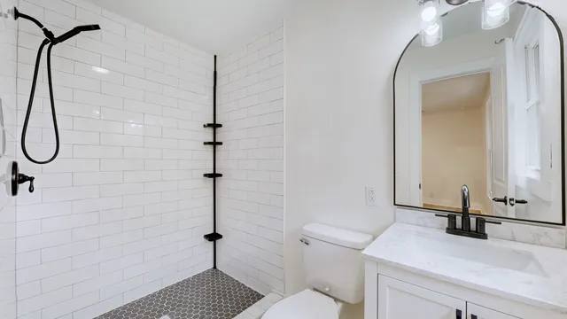 a bathroom with a toilet sink and mirror
