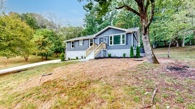 a view of a backyard with large trees