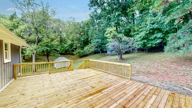 a front view of a house with a yard and potted plants