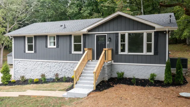 a aerial view of a house with a yard and potted plants