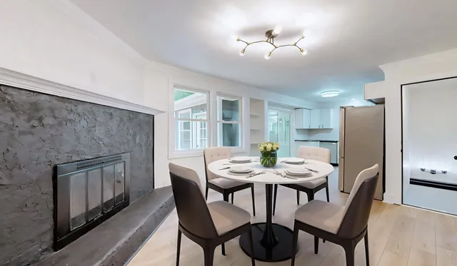 a view of a dining room with furniture and a chandelier