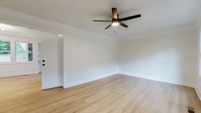 wooden floor in an empty room with a window