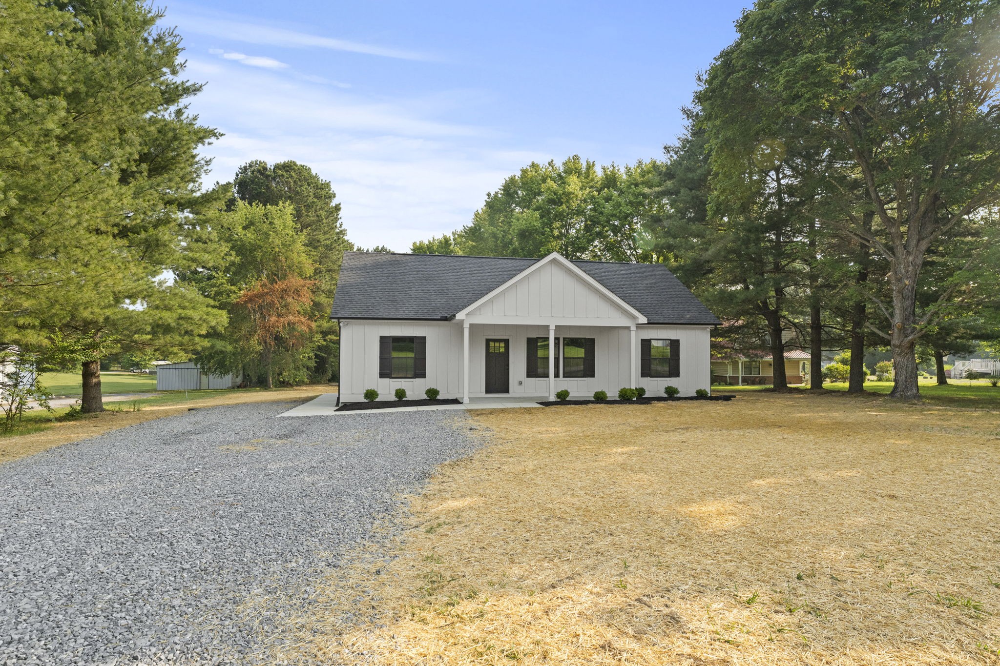 204 Point Road Portland, TN 37148 - Photo 3 of 51 a front view of a house with a yard and trees