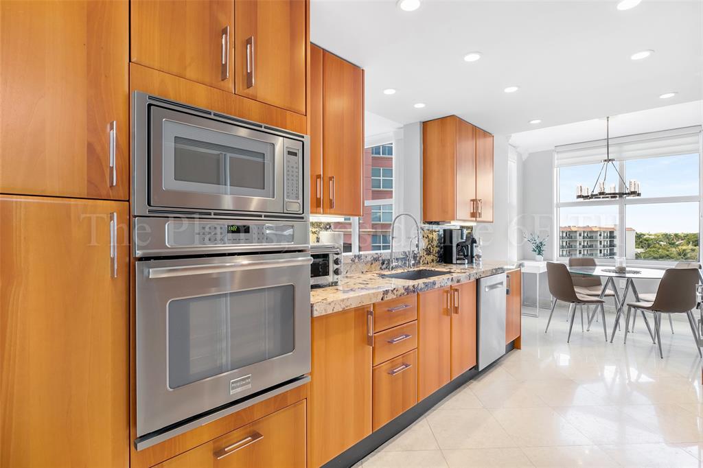 2110 North Ocean Boulevard, Unit 6F Fort Lauderdale, FL 33305 - Photo 14 of 51 a kitchen with stainless steel appliances granite countertop a stove microwave and sink