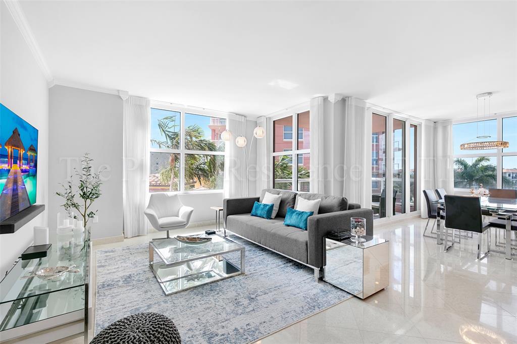 2110 North Ocean Boulevard, Unit 6F Fort Lauderdale, FL 33305 - Photo 2 of 51 a living room with furniture large window and a table