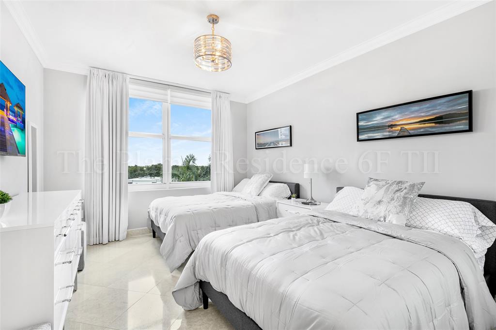 2110 North Ocean Boulevard, Unit 6F Fort Lauderdale, FL 33305 - Photo 25 of 51 a bedroom with two beds and a large window