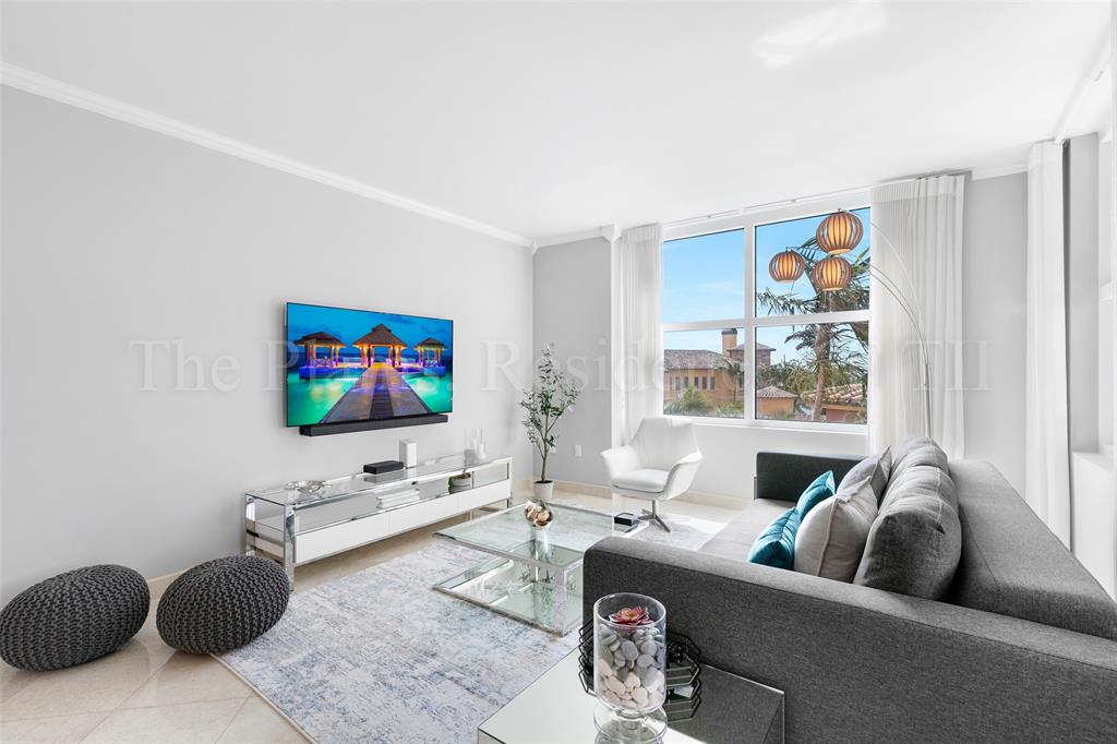 2110 North Ocean Boulevard, Unit 6F Fort Lauderdale, FL 33305 - Photo 5 of 51 a living room with furniture and a flat screen tv