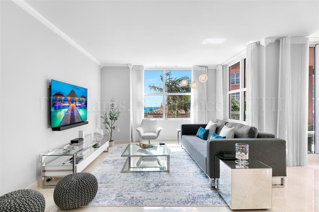 2110 North Ocean Boulevard, Unit 6F Fort Lauderdale, FL 33305 - Photo 6 of 51 a living room with furniture and a flat screen tv
