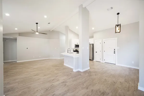 a view of a kitchen with a sink and a window