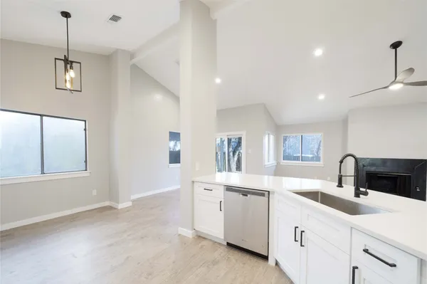 a kitchen with a sink stove and cabinets