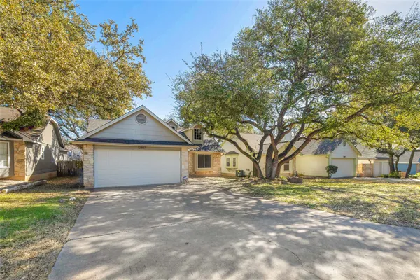 a front view of house with yard and trees around