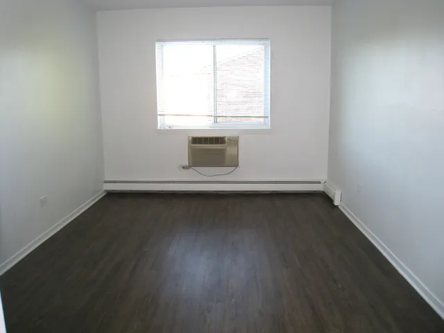 a view of a closet with wooden floor