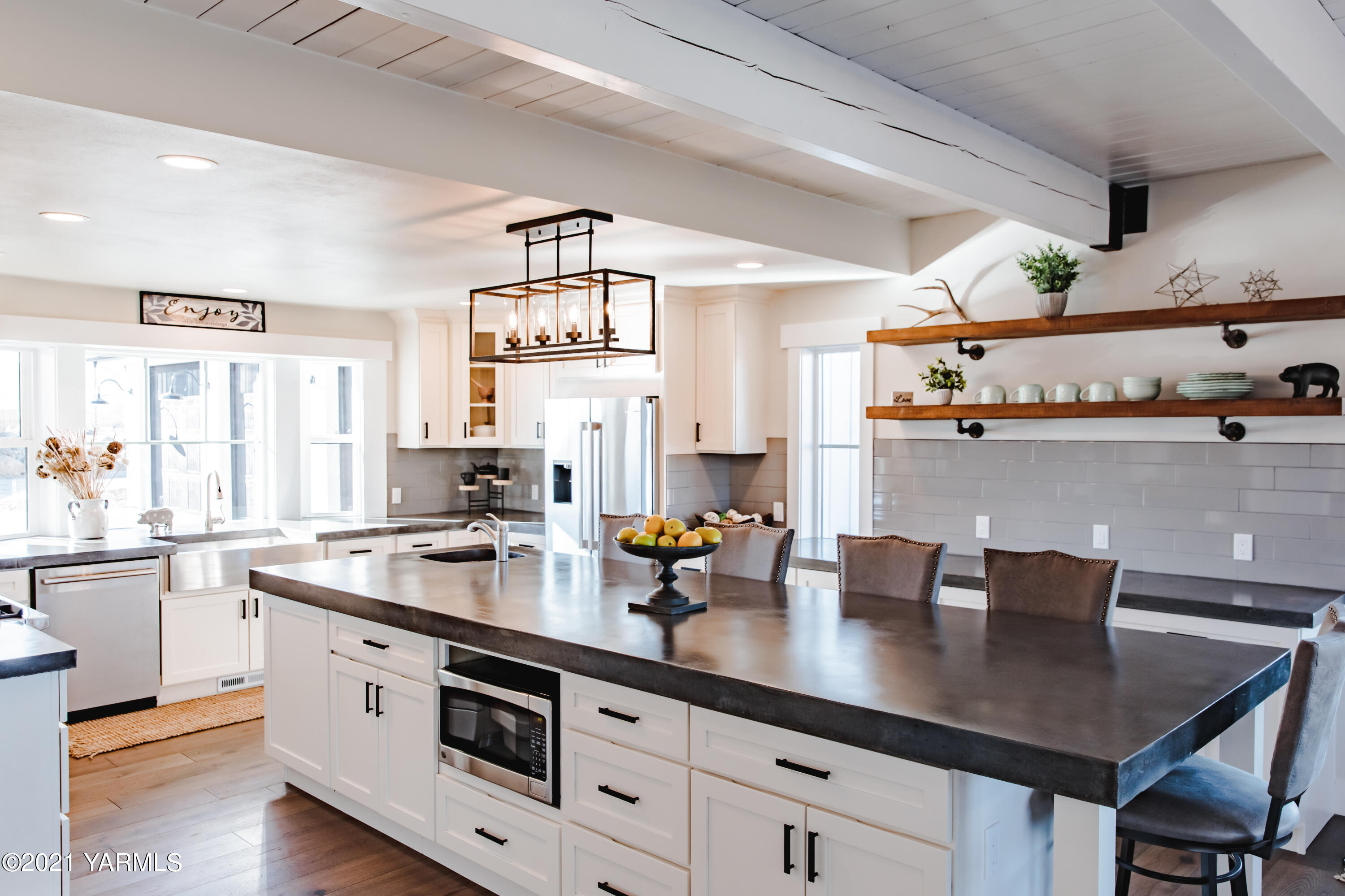 491 Elliott Road Cowiche, WA 98923 - Photo 11 of 49 a kitchen with a sink dishwasher a stove and white cabinets with wooden floor