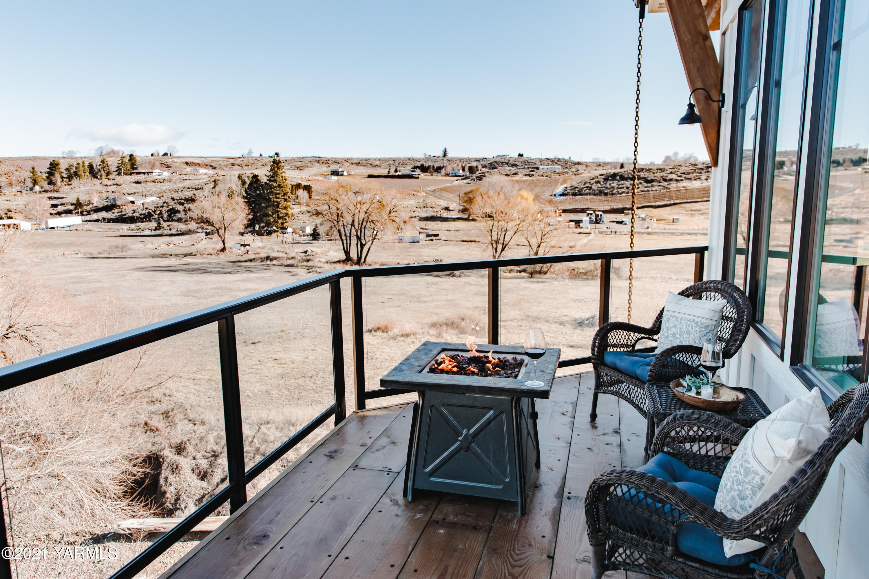 491 Elliott Road Cowiche, WA 98923 - Photo 21 of 49 a view of a balcony with chairs and wooden floor