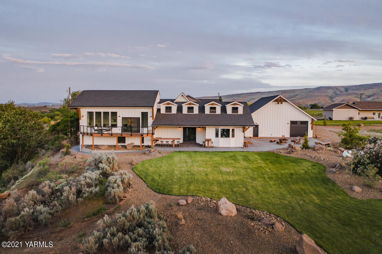 491 Elliott Road Cowiche, WA 98923 - Photo 46 of 49 a view of a big house with a big yard and large trees